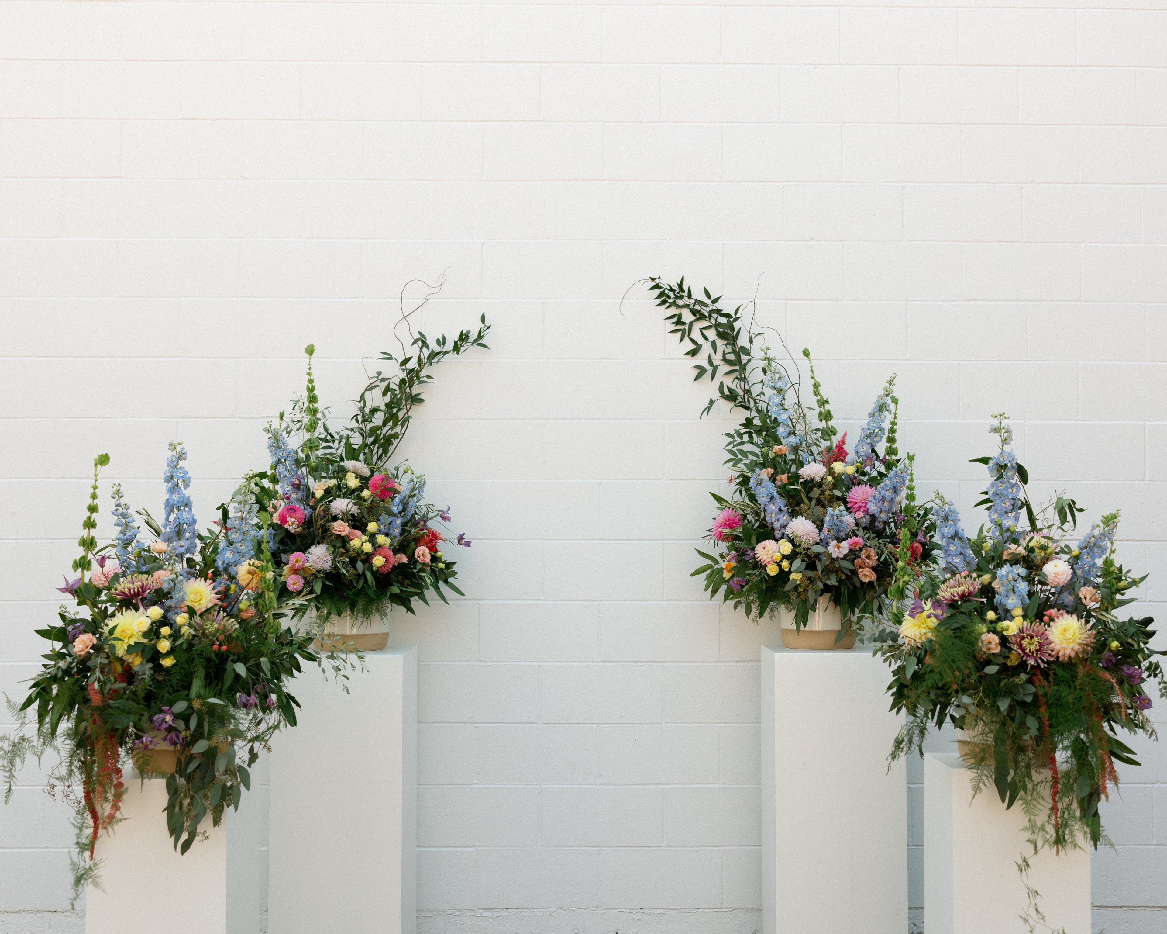 Fort Common Wedding, Ceremony Flowers against white all, Kiana Bryn Photography