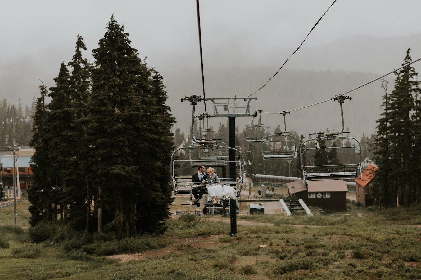 bride and groom riding a ski lift
