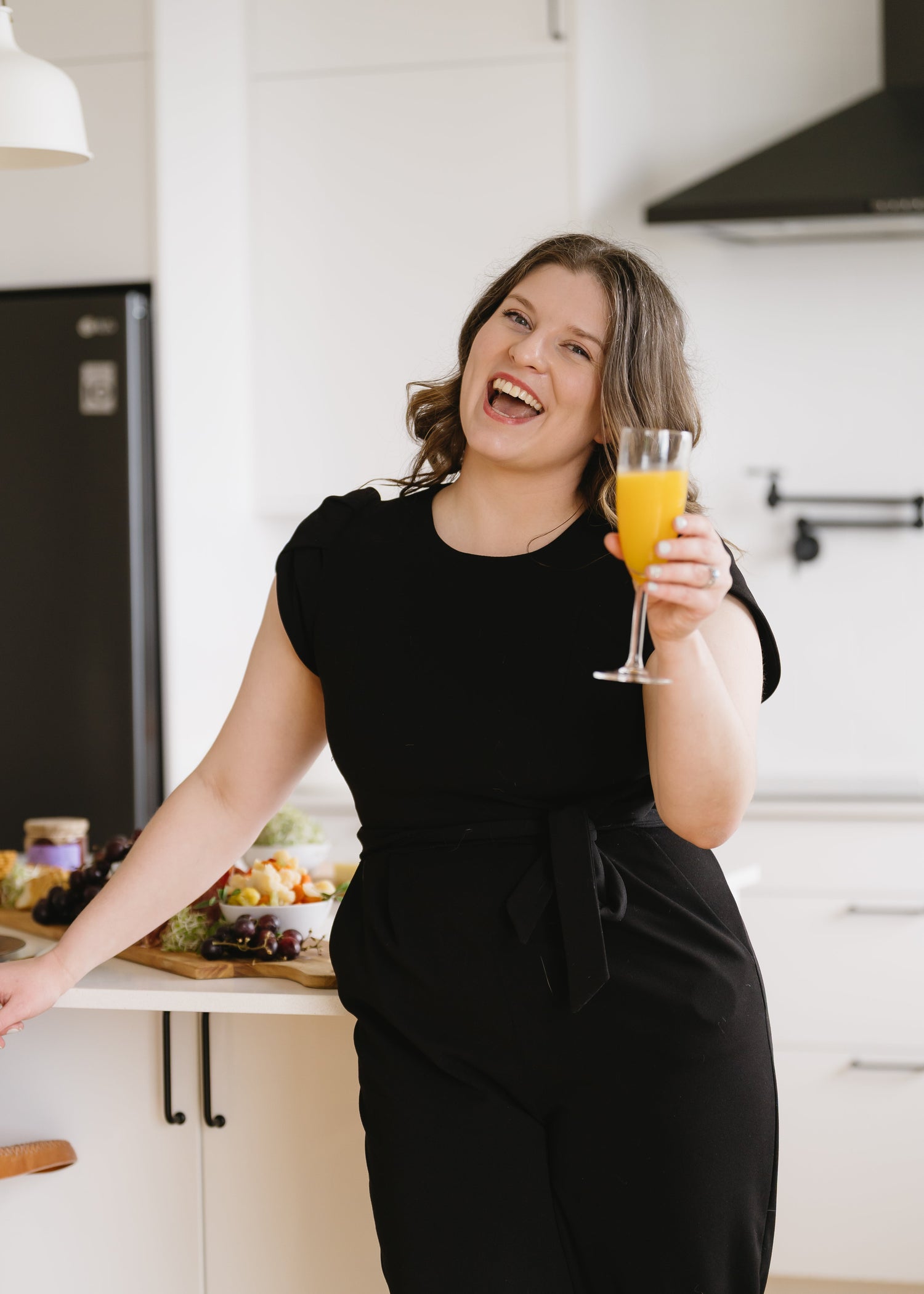 Nicole Grogan owner and lead planner of Intended Weddings and Events cheering with a glass of orange juice. Vancouver Island wedding planner, Victoria Wedding planner - Rebecca Crooks Photography