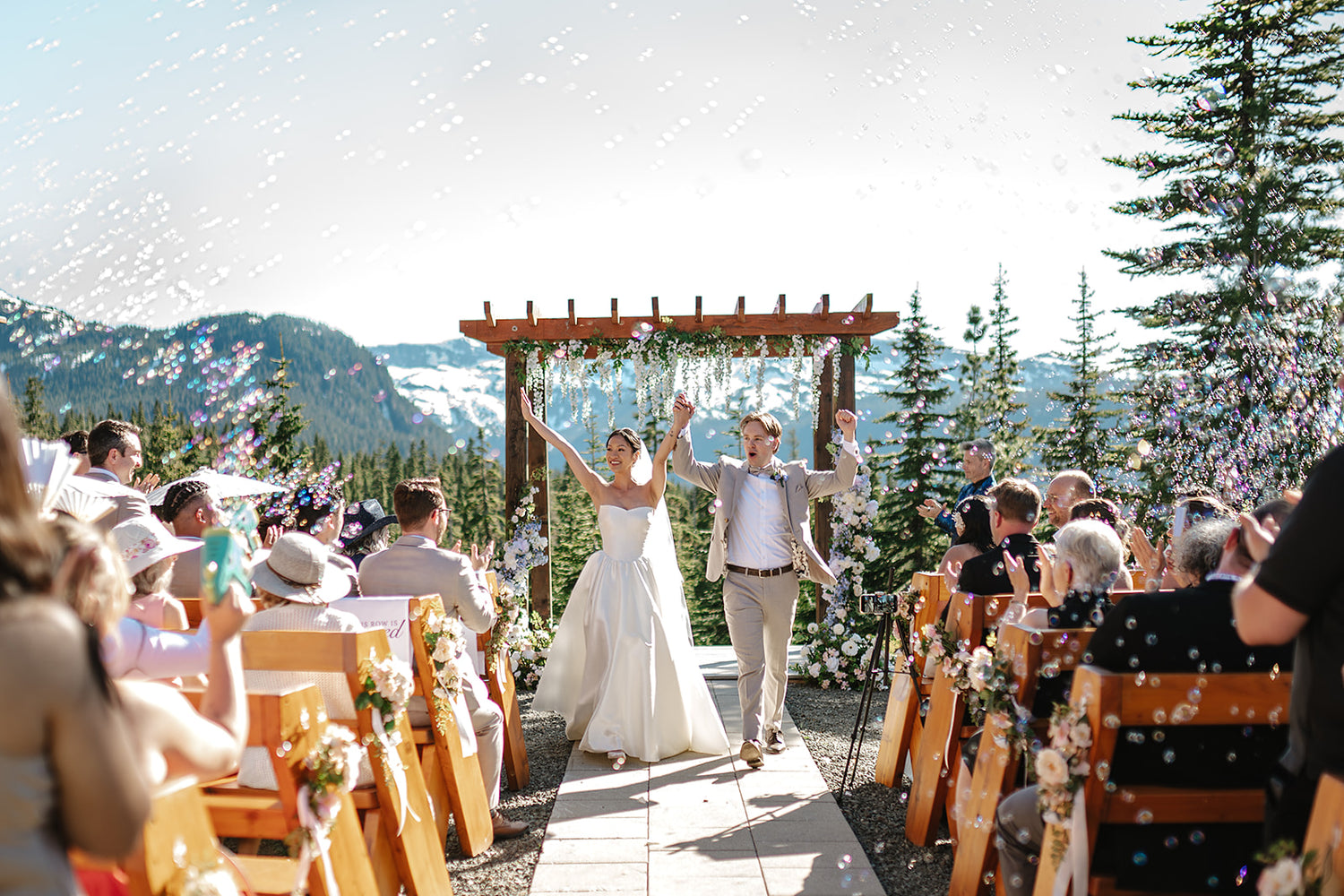 Bride and groom celebrating at mountain ceremony with bubbles in the air, Erin Wallis Photography, Vancouver Island Wedding, Intended Events