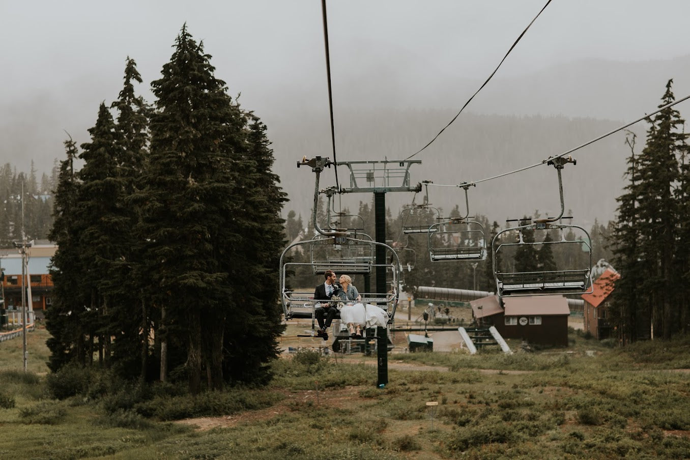 bride and groom riding a ski lift