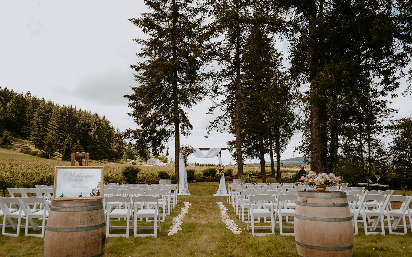 wedding ceremony set up with wine barrels and white chairs at Church and State Winery