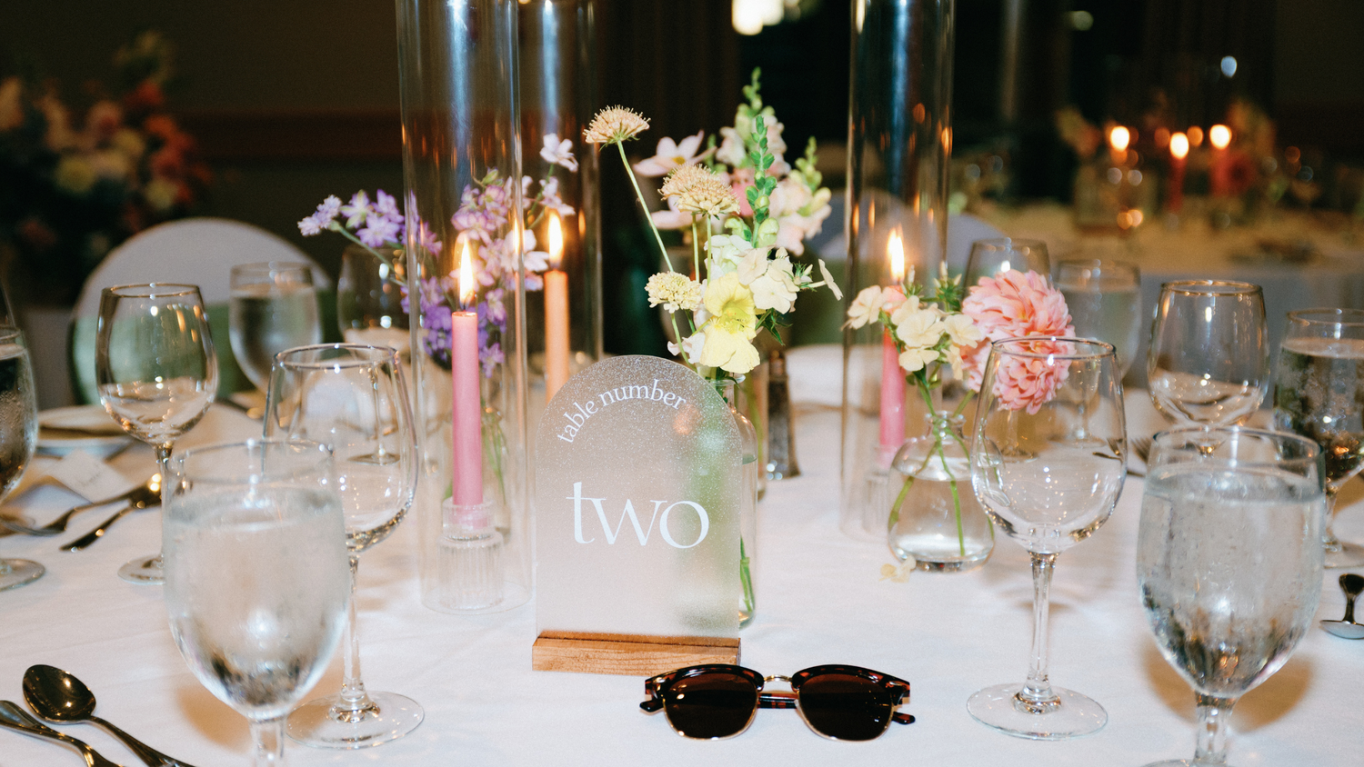 Colourful candles and flowers on a wedding table with sunglasses. Vancouver Island Wedding, West Coast Wedding, Tigh-Na-Mara Resort. Photo by Kea Mowat Photography
